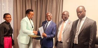 UWA 104B Concession Agreement to boost Tourism Ms. Patricia Akakunda of Russell Hall Ltd shaking hands with Prof. Kalema after signing the concession agreement. Right is Minister Martin Mugarra